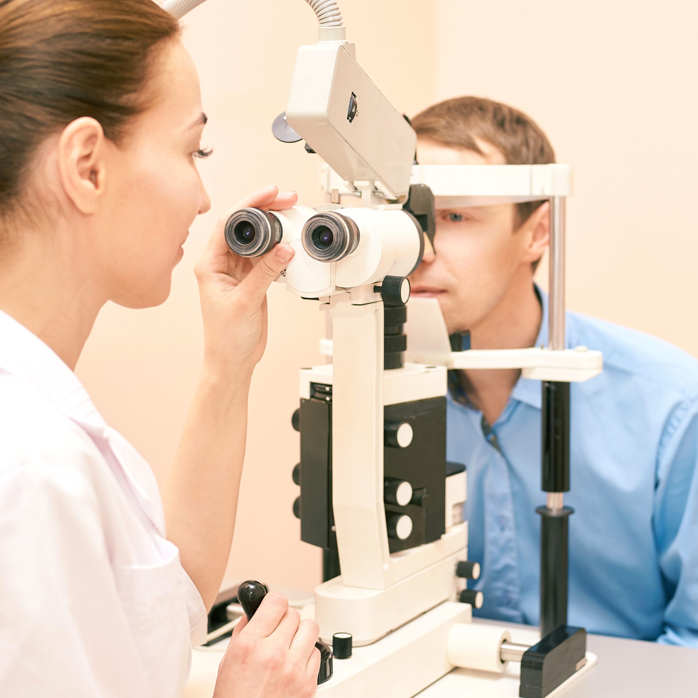 An optometrist examining a patient with an eye exam.