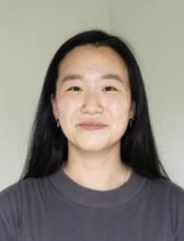 A young Korean woman smiling at the camera.